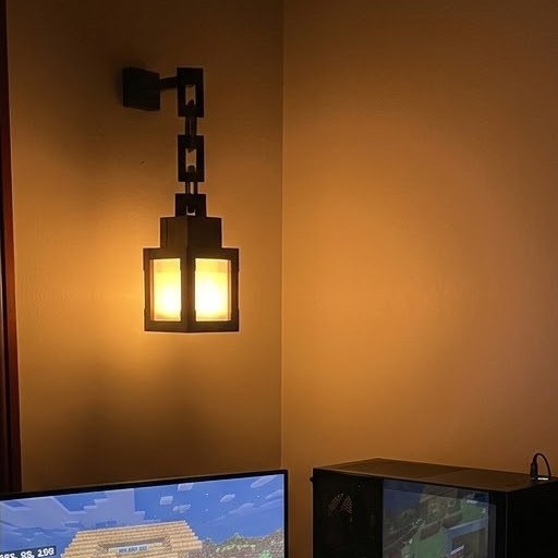 Gaming desk lit by the Relic Lantern on the wall
